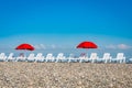 Sun loungers and red umbrellas on the beach in Batumi Royalty Free Stock Photo