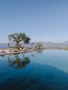 Sun loungers and sun umbrellas stand by the pool. Hotel Amanzoe, Greece Royalty Free Stock Photo