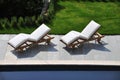 Sun loungers by a swimming pool Royalty Free Stock Photo