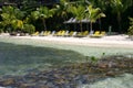 Sun loungers on tropical beach Royalty Free Stock Photo