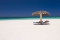 Sun loungers on tropical beach Royalty Free Stock Photo