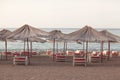 Sun loungers with an umbrella on the beach overlooking the sea Royalty Free Stock Photo