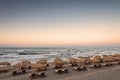 Sun loungers with umbrella on the beach, sunrise Royalty Free Stock Photo