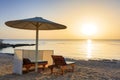 Sun loungers with umbrellas on the beach in Marsa Alam at sunrise, Egypt Royalty Free Stock Photo