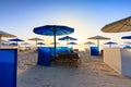 Sun loungers with umbrellas on the beach in Marsa Alam at sunrise, Egypt Royalty Free Stock Photo