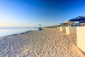 Sun loungers with umbrellas on the beach in Marsa Alam at sunrise, Egypt Royalty Free Stock Photo