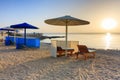 Sun loungers with umbrellas on the beach in Marsa Alam at sunrise, Egypt Royalty Free Stock Photo