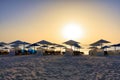 Sun loungers with umbrellas on the beach in Marsa Alam at sunrise, Egypt Royalty Free Stock Photo