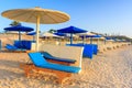 Sun loungers with umbrellas on the beach in Marsa Alam at sunrise, Egypt Royalty Free Stock Photo