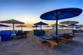 Sun loungers with umbrellas on the beach in Marsa Alam at sunrise, Egypt Royalty Free Stock Photo