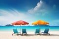 Sun loungers with umbrellas on the beach, summer vacation background.