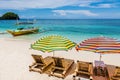 Sun lounges with umbrellas at Ilig Iligan Beach, Boracay Island, Philippines Royalty Free Stock Photo