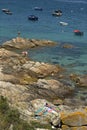 Sun lovers on rocky coast of Galicia, Spain Royalty Free Stock Photo