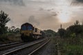 A Freight Train Passes An Evening Sky