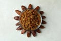 Sun made of dates and raisins on white textured background Royalty Free Stock Photo