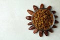 Sun made of dates and raisins on white textured background Royalty Free Stock Photo