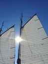 Sun Between Mainsail and Foresail of Sailboat Royalty Free Stock Photo