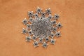 Sun or mandala made of metal medallion and findings on suede background