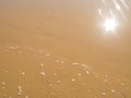 Sun mirrored in the wet sand beach Royalty Free Stock Photo