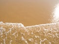 Sun mirrored in the wet sand beach