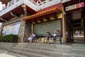 Sun Moon Lake, Taiwan - May 24, 2023: Three elder Ladys sitting on a bench at the Wenwu Temple. The temple offers grand