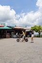 Sun Moon Lake, Taiwan - May 25, 2023: A young couple on a pink electric scooter, enjoying a carefree ride together, filled with