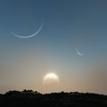 Sun and Moons Over The Hill Royalty Free Stock Photo