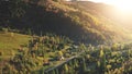 Sun mountain village at fir forest aerial. Autumn nobody nature landscape. Cottages at rural road Royalty Free Stock Photo