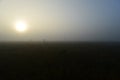 Sun over a forest swamp in thick fog at sunrise Royalty Free Stock Photo