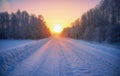 Sun over siberian rural empty road under the snow at morning time Royalty Free Stock Photo