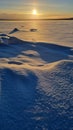 The sun over the snow-covered  lake in winter Royalty Free Stock Photo