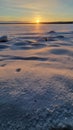 The sun over the snow-covered  lake in winter Royalty Free Stock Photo