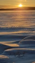 The sun over the snow-covered  lake in winter Royalty Free Stock Photo