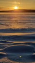The sun over the snow-covered  lake in winter Royalty Free Stock Photo