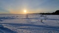 The sun over the snow-covered  lake in winter Royalty Free Stock Photo