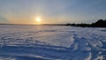 The sun over the snow-covered  lake in winter Royalty Free Stock Photo