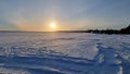 The sun over the snow-covered  lake in winter Royalty Free Stock Photo
