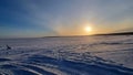 The sun over the snow-covered  lake in winter Royalty Free Stock Photo