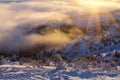 Sun over winter mountains, covered with snow. Royalty Free Stock Photo