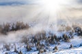 Sun over winter mountains, covered with snow. Royalty Free Stock Photo