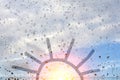 Drawing of the sun on the misted glass and raindrops Royalty Free Stock Photo