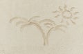 Sun and palm drawn on sand Royalty Free Stock Photo