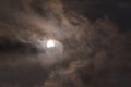The sun during a partial solar eclipse with dark clouds . Royalty Free Stock Photo
