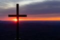 Sun peaks out from behind cross at dawn at Pretty place in South Carolina