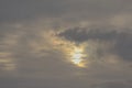 Sun peeking through dark storm clouds Royalty Free Stock Photo