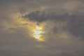 Sun peeking through dark storm clouds Royalty Free Stock Photo