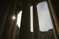 Sun peeking through doric columns.