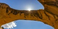 Sun peeking through Uranium Arch in Moab Utah Royalty Free Stock Photo