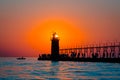 Sun perfectly framed in South Haven`s lighthouse at sunset in Michigan