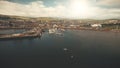 Sun pier town cityscape aerial. Seagull flight over ocean bay. Yachts, ships at marina. Old building Royalty Free Stock Photo